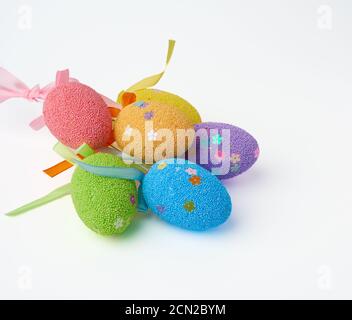 multi-colored decorative Easter eggs on sticks on a white background Stock Photo