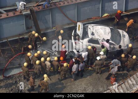 Firefighters and rescue workers search for victims at the site of an under-construction flyover after it collapsed in Kolkata, India, March 31, 2016. REUTERS/Rupak De Chowdhuri