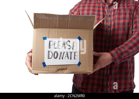 man in a plaid shirt and jeans holds a brown cardboard box with the inscription please donate Stock Photo