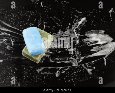 white soap foam and soap on a black background Stock Photo
