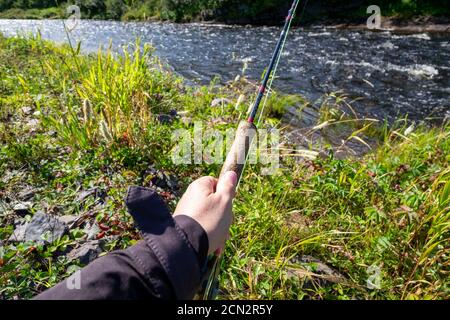 Fly fisher fishing on fast creek Stock Photo - Alamy