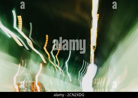 Driving in tunnel long exposure photo with colorful green and red defocused shaky lights. Italy. Campania Stock Photo