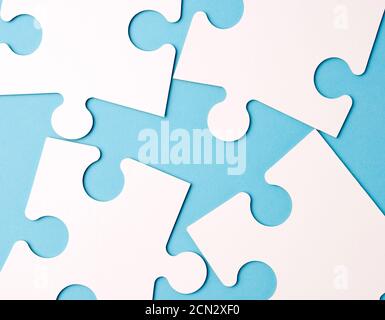 empty white big puzzles on a blue background. Concept in business Stock Photo