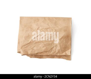 folded sheet of brown crumpled paper isolated on white background Stock Photo