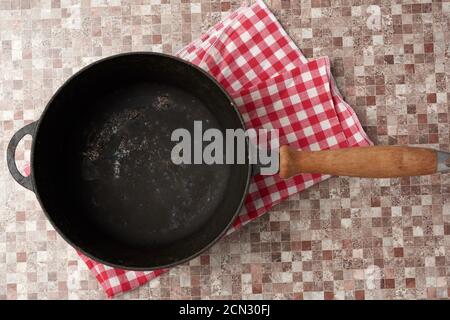 empty black round frying pan with wooden handle Stock Photo