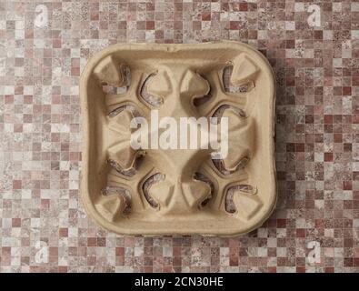 empty paper tray for drinks in takeaway cups on four cups on brown background Stock Photo