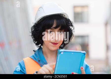 young construction engineer  female with helmet working outside Stock Photo