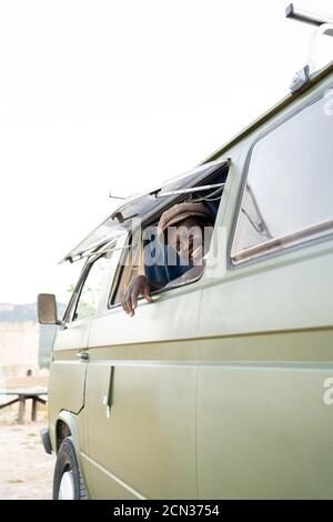 African American black man smiling in his green camper van Stock Photo