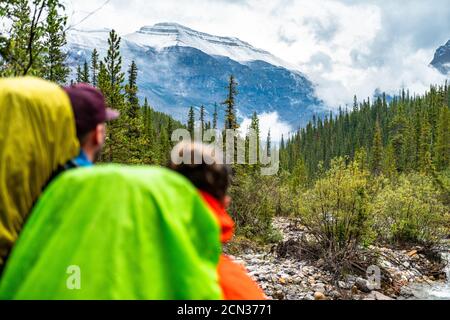 Couple Observing Fresh Snow on Nearby Mountain Peak During Hike Stock Photo