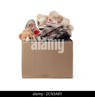 large brown cardboard box filled with things and children's toys, concept of moving Stock Photo
