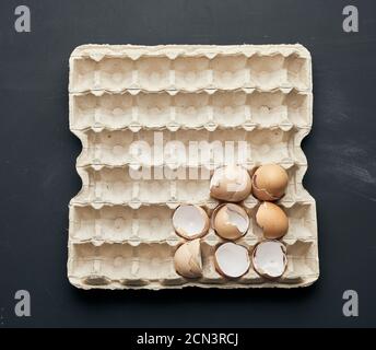 eggshell in a paper tray on a black wooden table Stock Photo