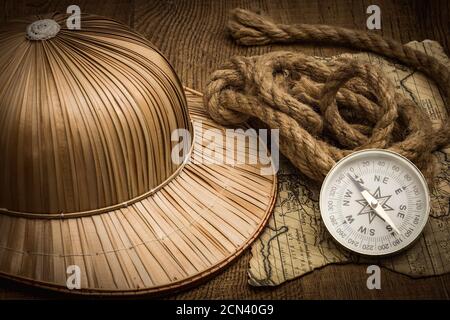 helmet on the background of an old colonial map with a compass Stock Photo