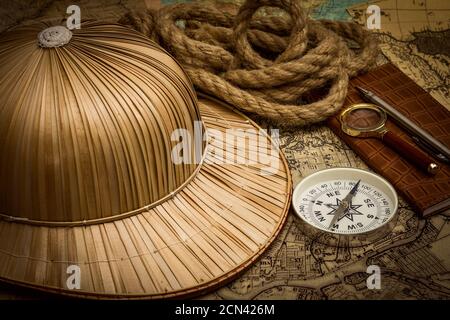 helmet on the background of an old colonial map with a compass Stock Photo