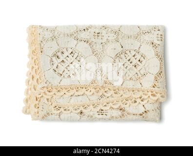 folded beige lace tablecloth and isolated on a white background Stock Photo