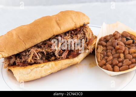 BBQ meal of pulled pork, baked beans, and butter toasted bread will taste as delicious as it looks. Stock Photo