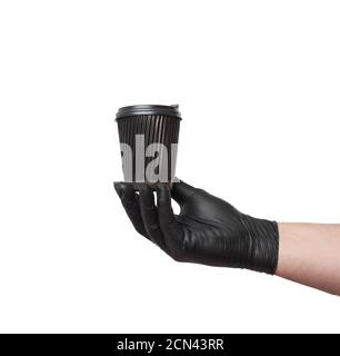 hand in a black latex glove holds a disposable cardboard cup and a plastic lid on a white background Stock Photo