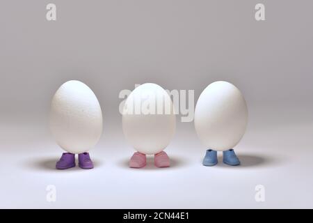 Three eggs are wrapped in multi-colored shoes, stand in the center. Stock Photo