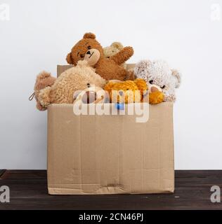 brown cardboard box filled with soft toys Stock Photo