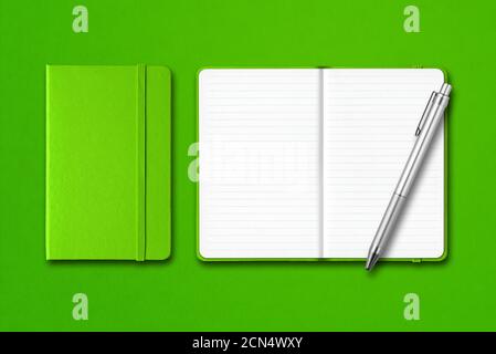 Green closed and open notebooks with a pen isolated on colorful background Stock Photo