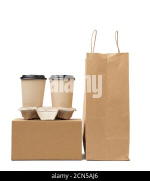 box, brown paper craft bag and disposable cups for hot drinks in tray are isolated on white backgrou Stock Photo