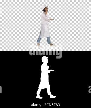 Female scientist making a call walking, Alpha Channel Stock Photo