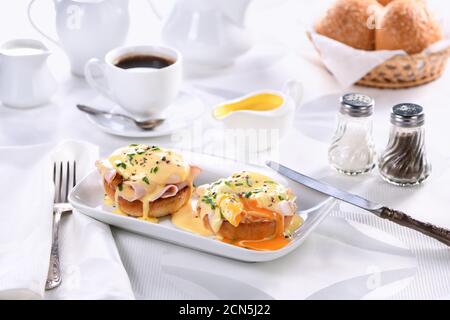 Breakfast. Best Eggs Benedict - fried English bun, ham, poached eggs and delicious Hollandaise   but Stock Photo
