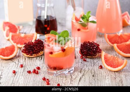 Tequila cocktail with pomegranate and grapefruit juice, tinted with the aroma of a fresh sprig of mi Stock Photo