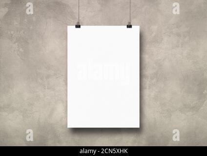 White poster hanging on a light concrete wall with clips Stock Photo