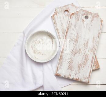 empty rectangular white cutting kitchen board and round plate on a wooden background Stock Photo