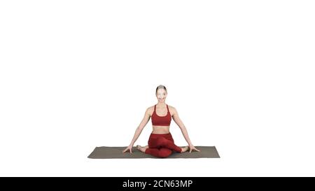 Young attractive woman practicing yoga, sitting in Gomukasana ex Stock Photo