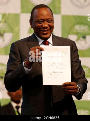 Incumbent President Uhuru Kenyatta holds the certificate of President-Elect of the Republic of Kenya after he was announced winner of the repeat presidential election at the IEBC National Tallying centre at the Bomas of Kenya, in Nairobi, Kenya October 30, 2017. REUTERS/Thomas Mukoya