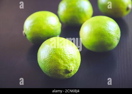 Group of fresh organic limes on a black background Stock Photo