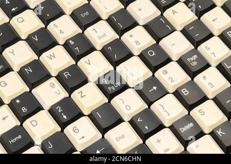 a set of keys from old computer keyboards laid out on the table in a staggered manner Stock Photo