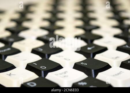 a set of keys from old computer keyboards laid out on the table in a staggered manner Stock Photo