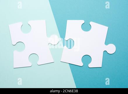 empty white big puzzles on a blue background. Concept in business, close up Stock Photo