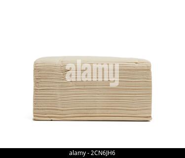 stack of paper disposable beige folded square napkins on a white background Stock Photo