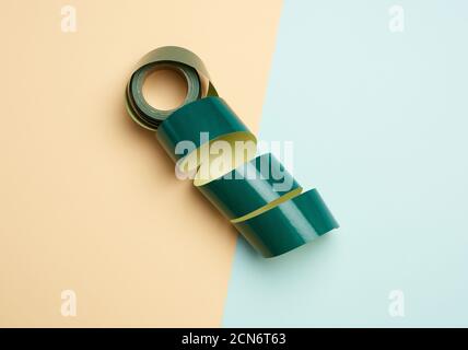 roll of rolled paper sticky tape on colored background Stock Photo