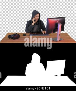 Experienced hacker answers someones call, Alpha Channel with Sil Stock Photo