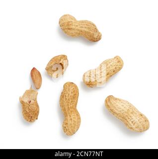 heap of peanuts in shell and broken, food isolated on white background, close up Stock Photo