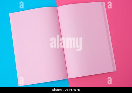 open notebook with blank pink pages on a blue background Stock Photo
