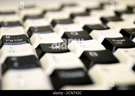 a set of keys from old computer keyboards laid out on the table in a staggered manner Stock Photo