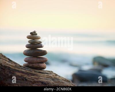 Balanced stone pyramide on sea shore Stock Photo