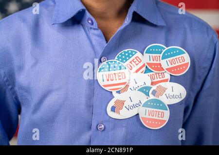 Close up of multiple I Voted stickers on blue shirt - Concept of US election voter fraud by placing multiple voting stickers Stock Photo
