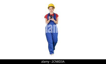 Female worker walking and using phone on white background. Stock Photo