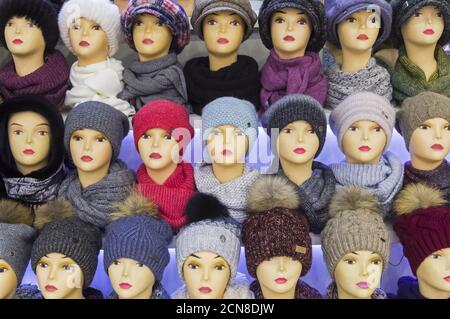 Mannequin heads in knitted hats and scarves. Stock Photo