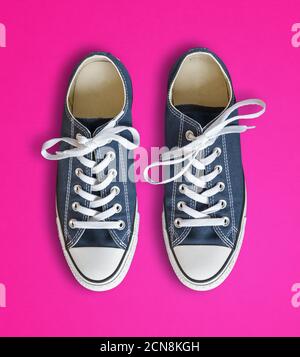 Blue sneakers isolated on pink background Stock Photo