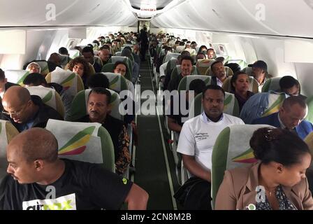 Passengers sit inside an Ethiopian Airlines ET314 flight to Eritrea's capital Asmara at the Bole International Airport in Addis Ababa, Ethiopia July 18, 2018. REUTERS/Tiksa Negeri