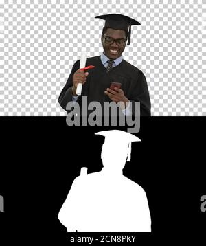 Smiling african american male student in graduation robe with di Stock Photo