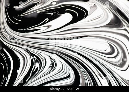 abstract black and white swirls pattern on liquid glossy paint surface background Stock Photo