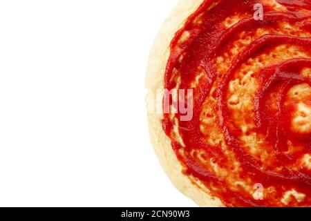 Rolled out pizza dough with sauce isolated on white background Stock Photo